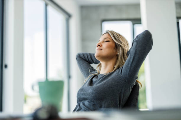 istock Smiling female entrepreneur resting with her eyes closed. 1921534911