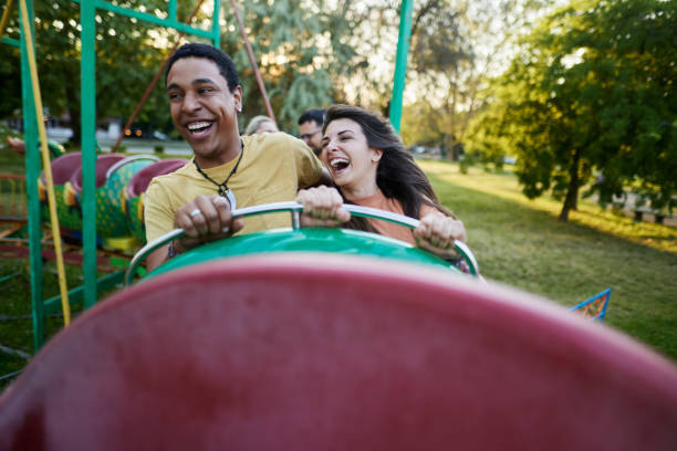 istock Young cheerful couple having fun on rollercoaster at amusement park. 1921551766
