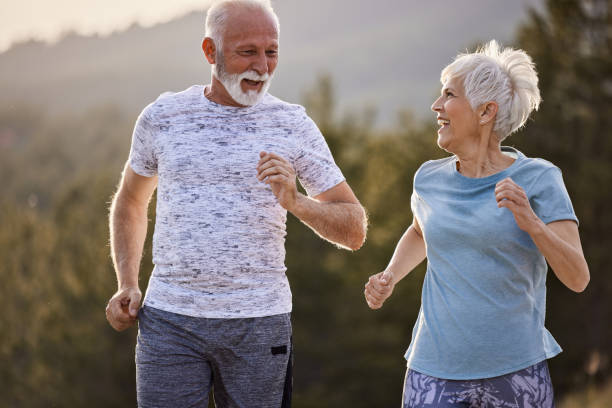 istock Happy senior couple talking while jogging in nature. 1921564928