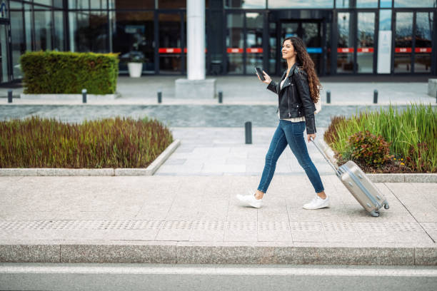 istock Woman traveler with suitcase 1921573500