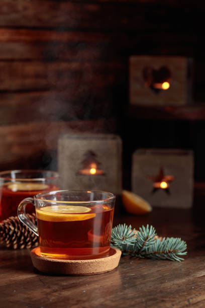 istock Tea with lemon and small Christmas lanterns on a wooden table. 1921577238