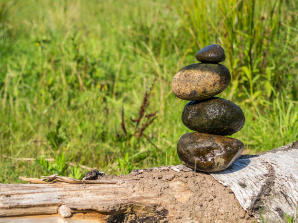 Balance stones on a bank with a meadow