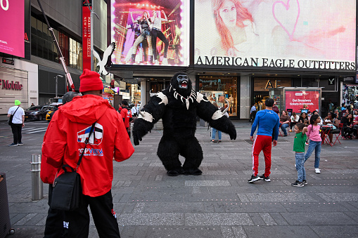 Times Square, Manhattan, New York, USA, April 12, 2023 - A man in a gorilla costume (King Kong) walks through Times Square in New York City.