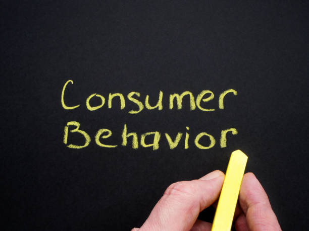 istock Consumer behavior inscription and hand with chalk. 1921637956