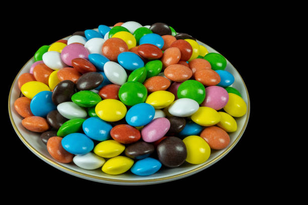 istock Round milk chocolate balls on a plate on a black background 1921640161