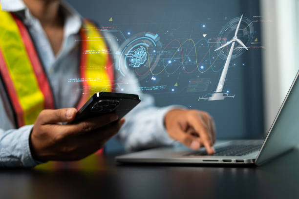 istock Engineers use AI artificial intelligence to inspect wind turbines and analyze the data of the electricity generated using hologram HUD. Clean energy technology and renewable energy. 1921640670