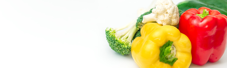 Colorful bell peppers on white background with copy space.