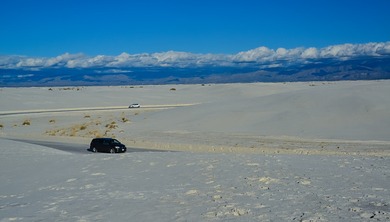 USA, NEW MEXICO - NOVEMBER 23, 2019: car rides the harms of sand dunes from gypsum to White Sands National Monument, New Mexico, USA
