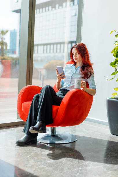 istock Balancing Work and Relaxation: Young Professional or Student Enjoying Sunbathing in a Comfortable Red Chair 1921691330