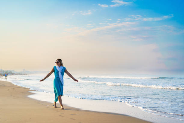 Beautiful woman walking on beach