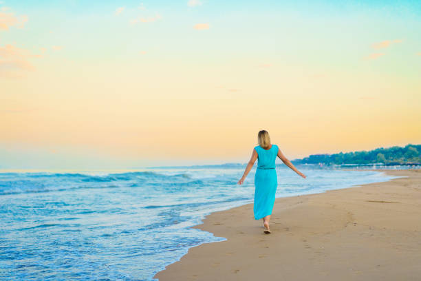 Beautiful woman walking on beach