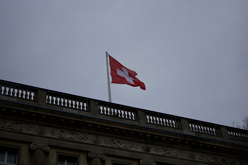 Berlin, Germany, January 03, 2024, Swiss Flag on rooftop of the Swiss embassy in Berlin.