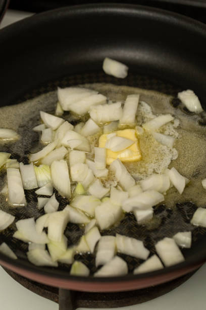 istock Finely chopped onions are fried in butter 1921704872