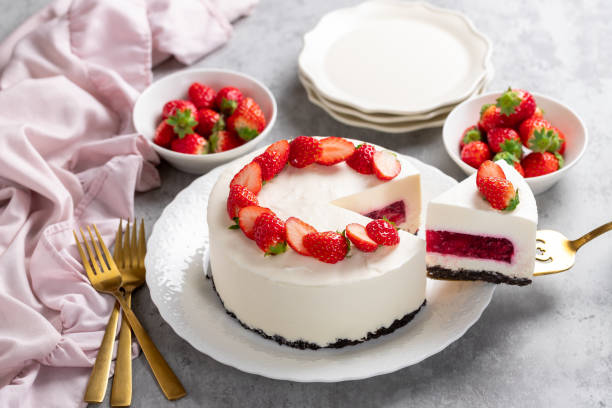 istock No bake cheesecake with fresh strawberries on top on a white plate on a gray concrete background. 1921706546