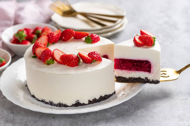 istock No bake cheesecake with fresh strawberries on top on a white plate on a gray concrete background. 1921706744