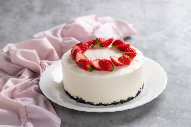 istock No bake cheesecake with fresh strawberries on top on a white plate on a gray concrete background. 1921707032