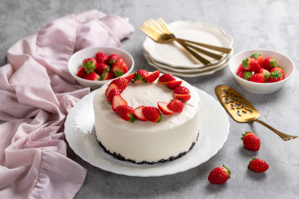 istock No bake cheesecake with fresh strawberries on top on a white plate on a gray concrete background. 1921707049