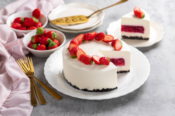 istock No bake cheesecake with fresh strawberries on top on a white plate on a gray concrete background. 1921707050
