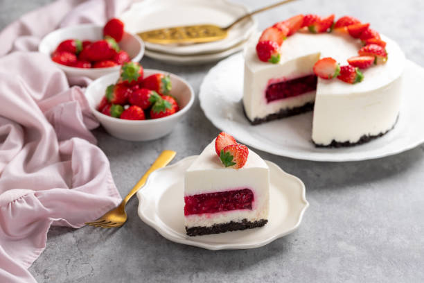 istock No bake cheesecake with fresh strawberries on top on a white plate on a gray concrete background. 1921707056
