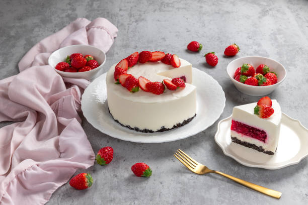 istock No bake cheesecake with fresh strawberries on top on a white plate on a gray concrete background. 1921707071