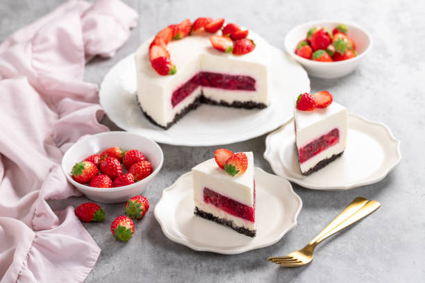 istock No bake cheesecake with fresh strawberries on top on a white plate on a gray concrete background. 1921707073