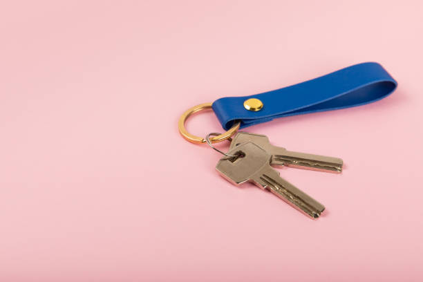 istock Keychain with key ring isolated on a colored background. Concepts for real estate and moving home or renting property. Buying a property. Mock-up keychain.Copy space. 1921708181