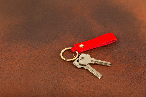 Keychain with key ring isolated on a colored background. Concepts for real estate and moving home or renting property. Buying a property. Mock-up keychain.Copy space.