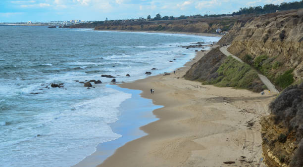 istock Wide sandy beach where people walk during a storm, Pacific Ocean, Malibu area 1921709257