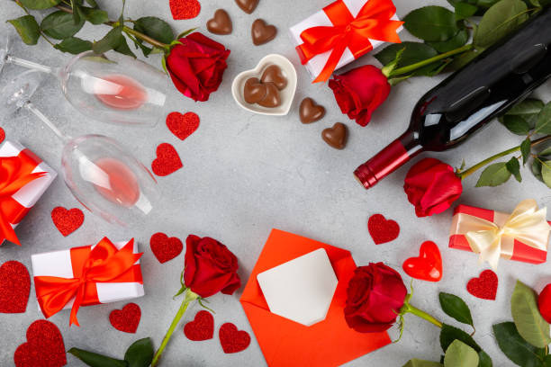 istock Valentine's Day concept. Valentine's Day background. Gifts, candles, confetti, envelope - postcard, sweets, glasses, wine and a bouquet of roses on background. Flatley, top view. 1921710317