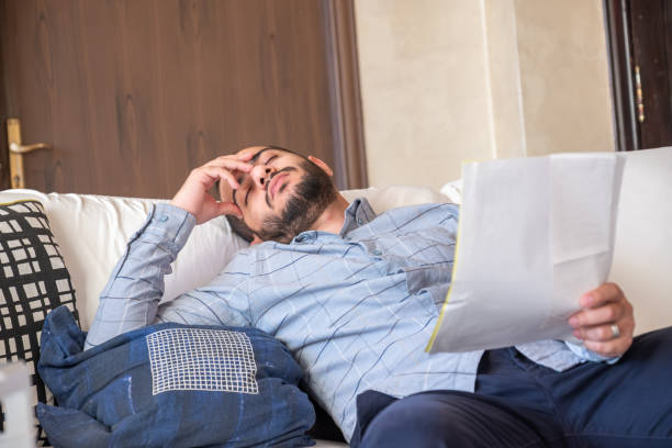 istock male holding bank card while feeling stressed due to financial issue 1921721557