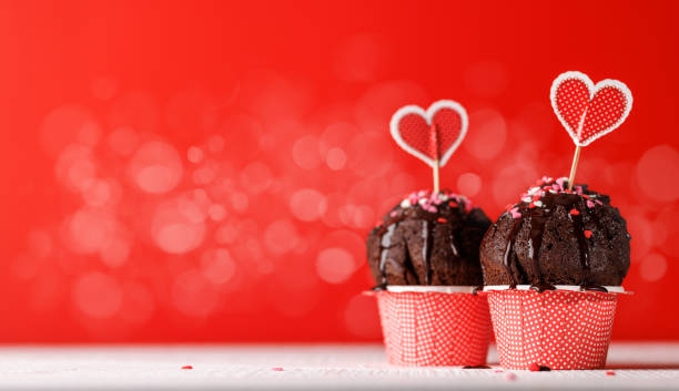 istock Cupcake love: Heart-themed treats on a vibrant red backdrop 1921728453