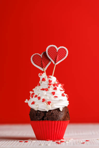 istock Cupcake love: Heart-themed treats on a vibrant red backdrop 1921729489