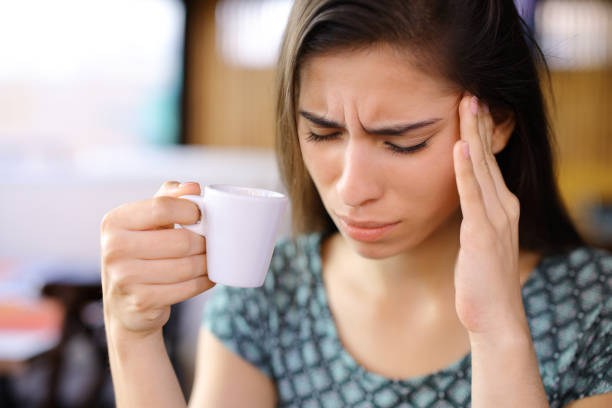 istock Woman drinking coffee suffering head ache 1921732578
