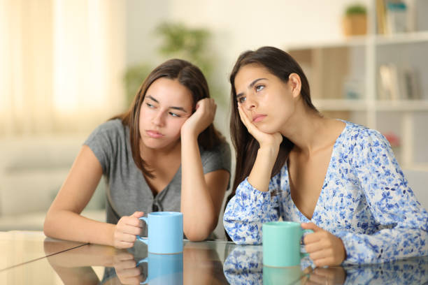 istock Two bored friends drinking coffee at home 1921732596