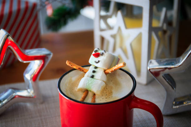 istock Red mug with hot chocolate with melted marshmallow snowman 1921733639