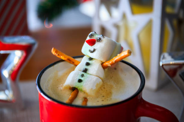 istock Red mug with hot chocolate with melted marshmallow snowman 1921733661