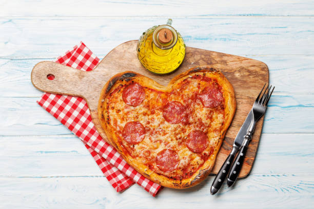 istock Heart-shaped pizza: Delicious love-themed dish 1921735235