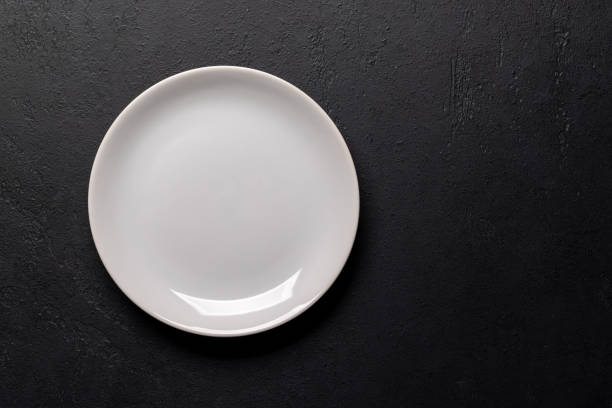 istock Mockup for a delicious meal. Empty plate on a table 1921737969