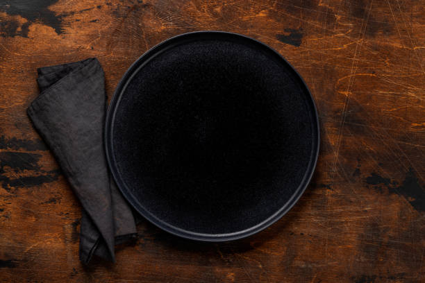 istock Mockup for a delicious meal. Empty plate on a table 1921738490