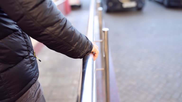 Man comes down holding on to metal railing slow motion 4k movie