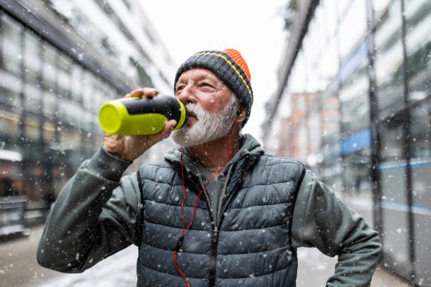 Senior Man Staying Hydrated Amidst Urban Exercise