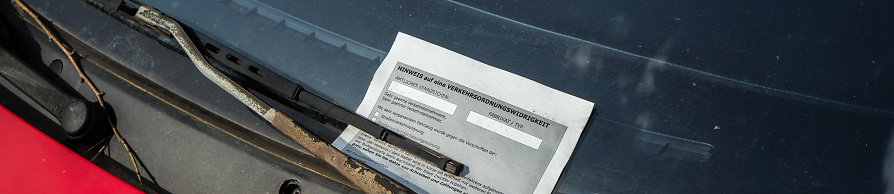 Panorama parking ticket on the window of a parked car