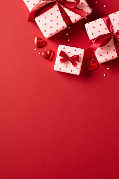 istock Valentine's day February 14 greeting card, banner, poster template. Flat lay composition with gift boxes and hearts on red background. 1921760095