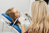 Doctor treats a patient teeth with dental drill. Orthodontist and prosthetics appointment. Hygiene and teeth healthy. Dentist and patient at medical center.