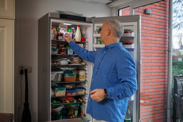 istock Handsome husband cooking at home 1921776601