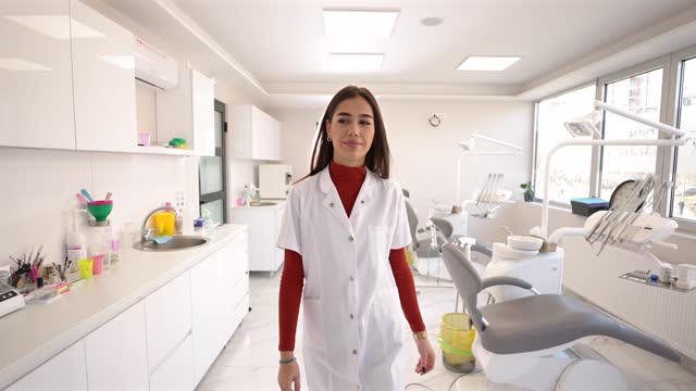 Young female dentist at work place