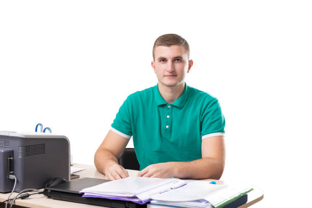 The medical worker sits at a desk on a white background. The medical clinic employee works with documents.