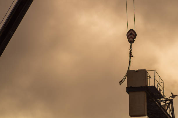 istock The coupling lifting hooks strike the high-altitude platform in a big way. Workplace hazards at a high-altitude facility, injuries, fatalities and accidents in construction building 1921851279