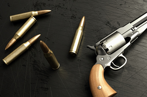 Old Pistol and Bullets on Black Surface. 3D Render