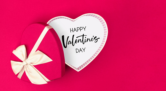 Heart shaped Valentine’s day gift box with message on red background